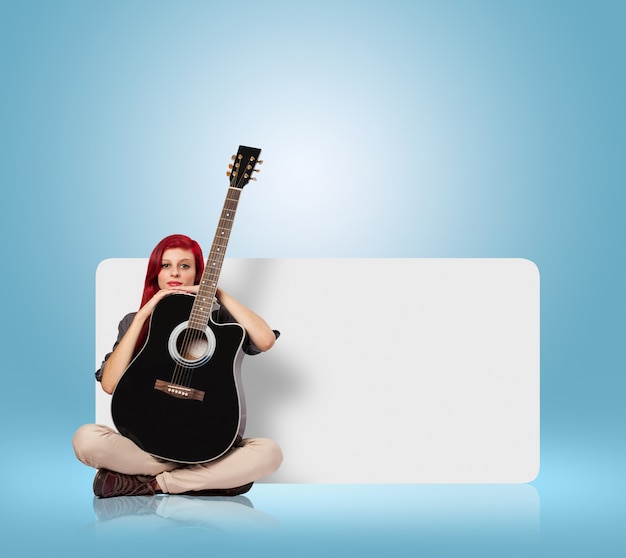 Free photo young woman holding a classic guitar against a banner