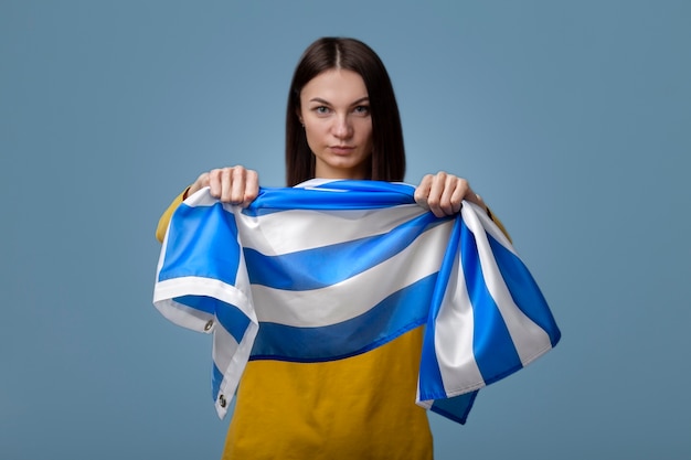 Free photo young woman holding greece flag