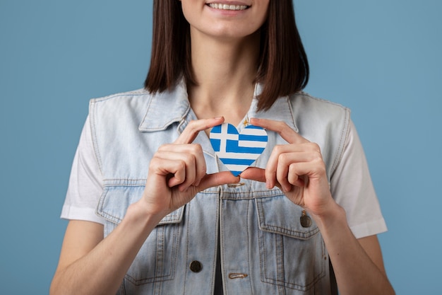 Free photo young woman holding greece flag