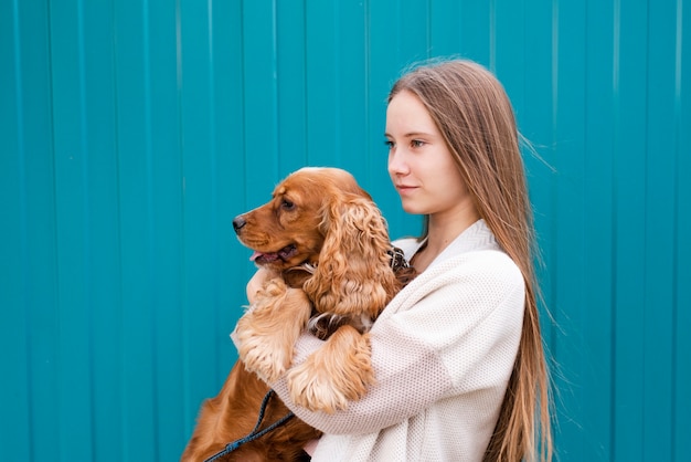 Free Photo young woman holding her cute dog