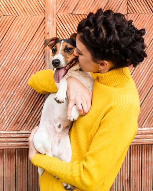 Young woman holding her puppy