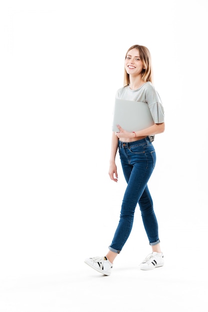 Free photo young woman holding laptop computer