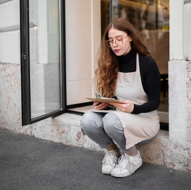 Young woman holding menu