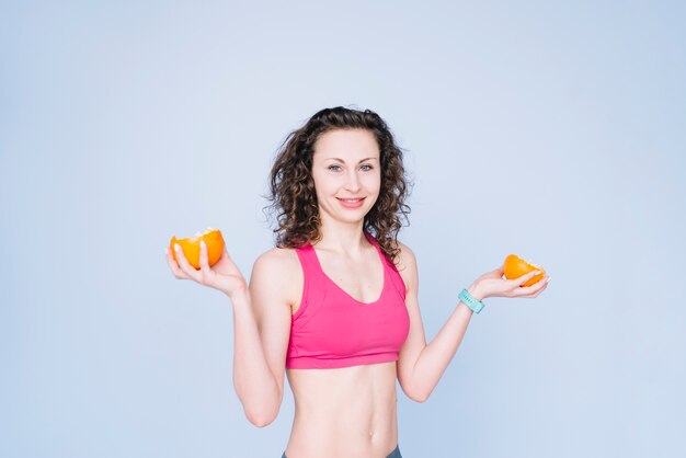 Young woman holding an orange