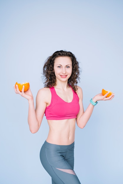 Young woman holding an orange