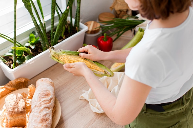 Free Photo young woman holding organic corn