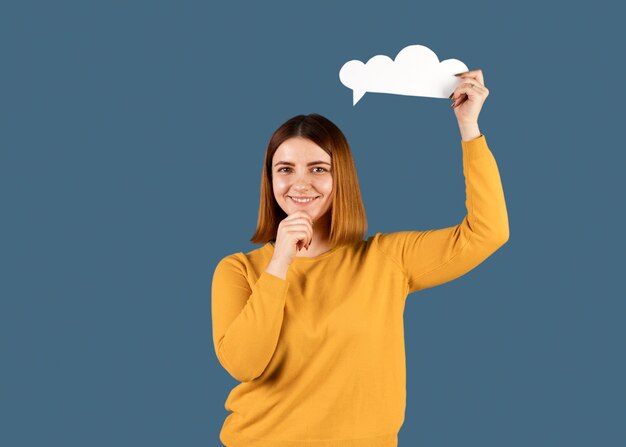 Young woman holding a thought bubble