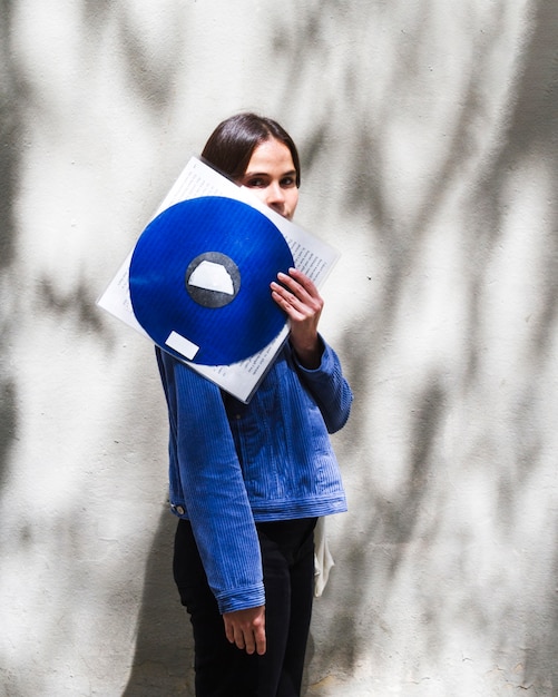 Free Photo young woman holding a vinyl record