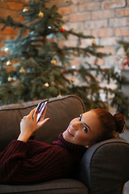 Young woman at home with Christmas decoration