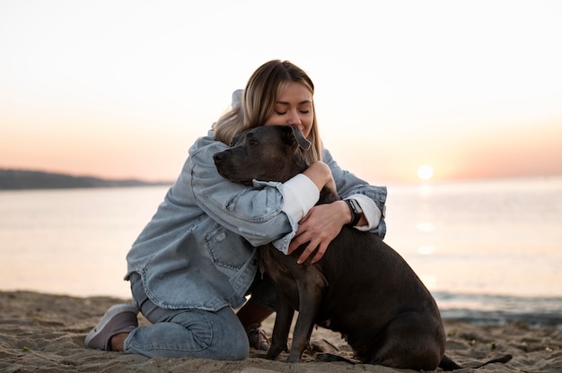 Free Photo young woman hugging her pitbull