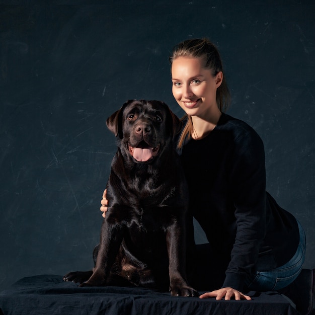 The young woman hugging a mix breed dog