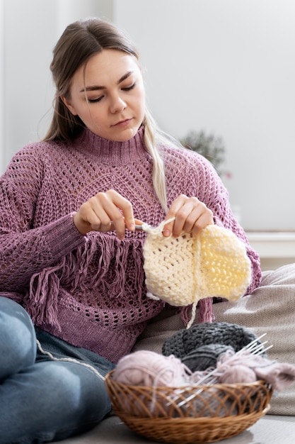 Young woman knitting while relaxing