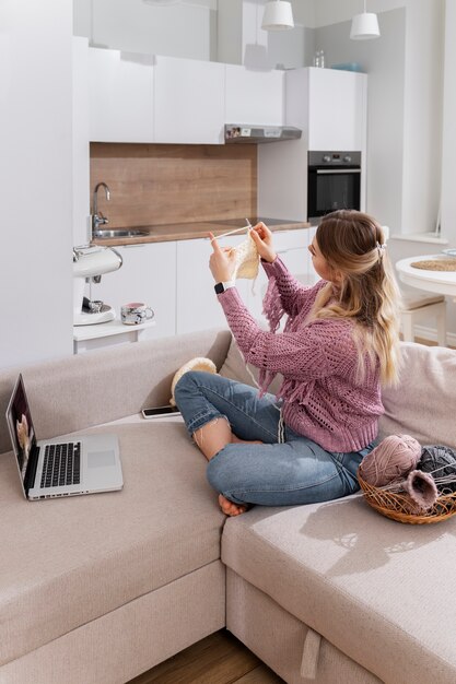 Young woman knitting while relaxing