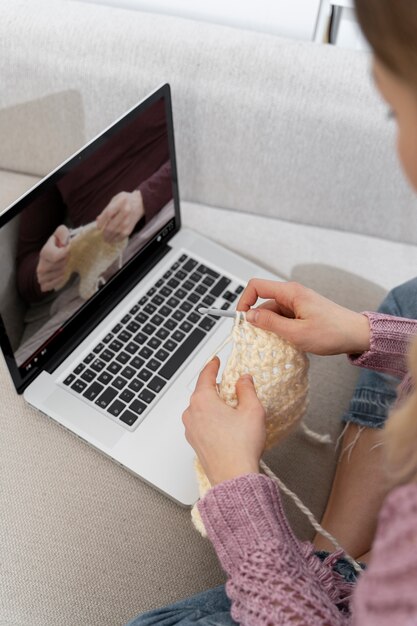 Young woman knitting while relaxing