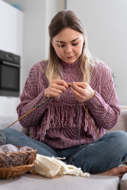 Young woman knitting while relaxing