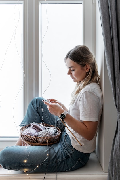 Young woman knitting while relaxing