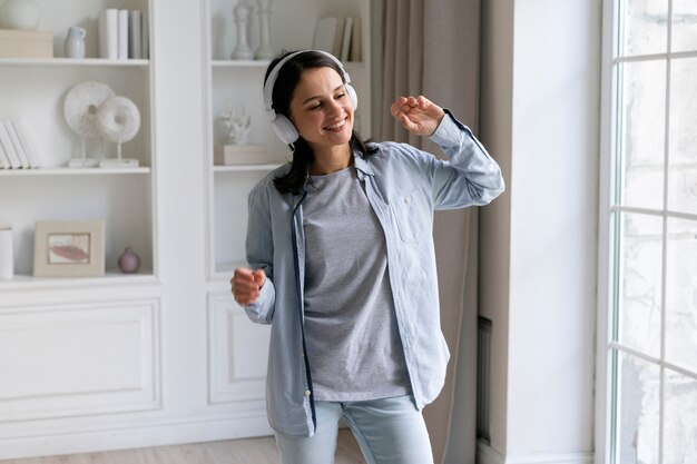 Young woman listening to music at home