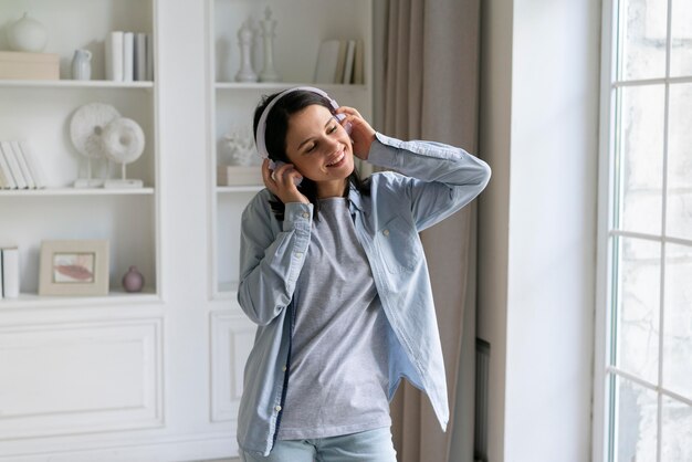 Young woman listening to music at home