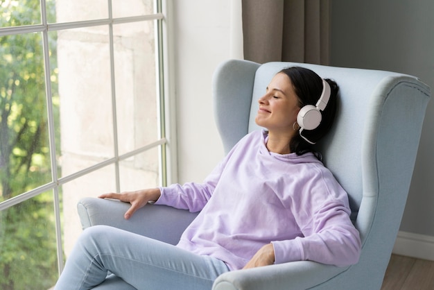 Young woman listening to music at home