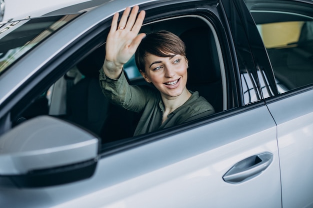 Young woman looking through the window car