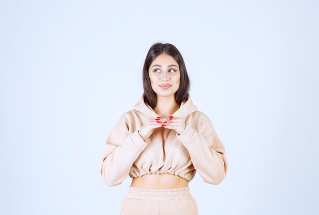 Young woman looks thoughtful as she is thinking and planning