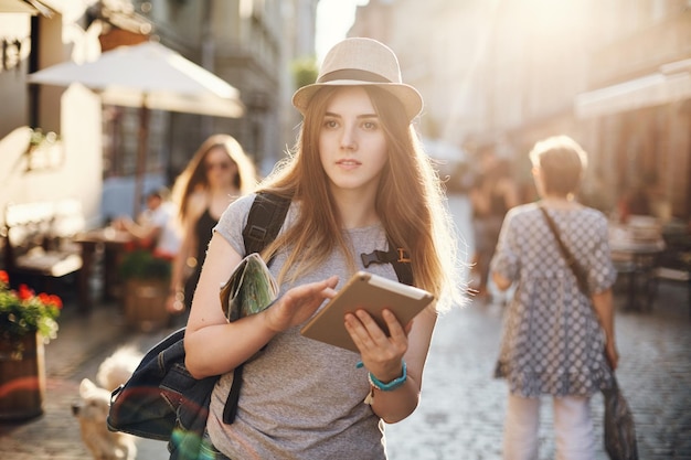 Young woman lost in the city travelling across the globe Joy of sightseeing in her eyes Travel lifestyle concept