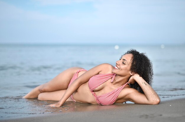 young woman lying on a beach