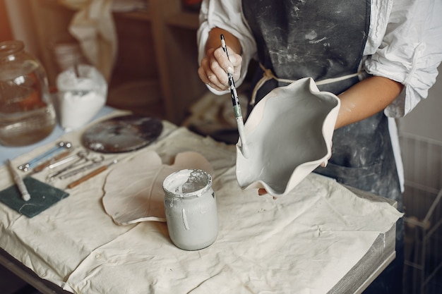 Free Photo young woman makes pottery in workshop