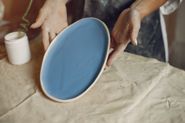 Free Photo young woman makes pottery in workshop