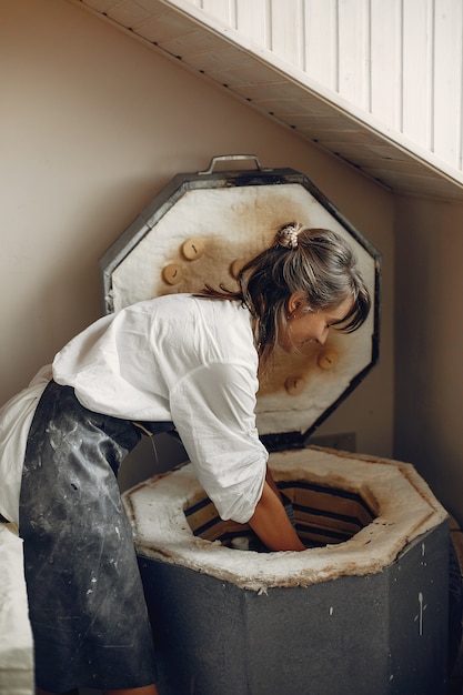 Free Photo young woman makes pottery in workshop