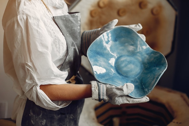 Free Photo young woman makes pottery in workshop