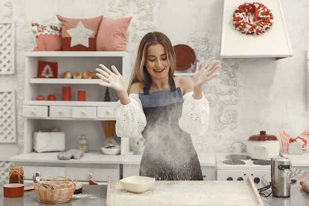 Free photo young woman making shaped cookies.