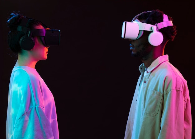 Free photo young woman and man with vr glasses face to face