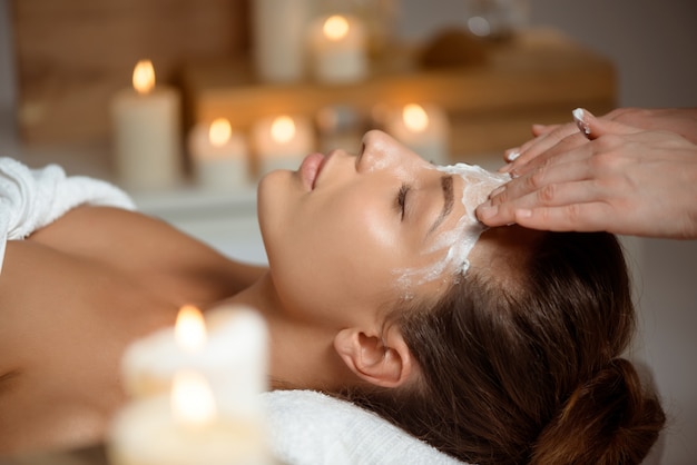 Free photo young woman in mask for face relaxing in spa salon.