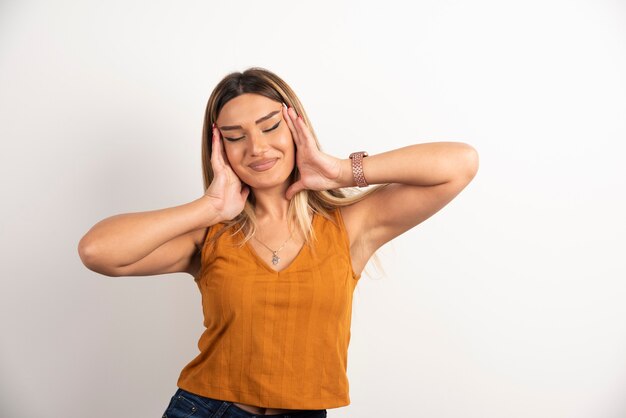 Young woman model in casual clothes posing on white background.