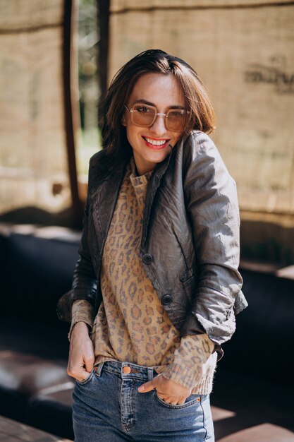 Young woman model in jacket posing outside