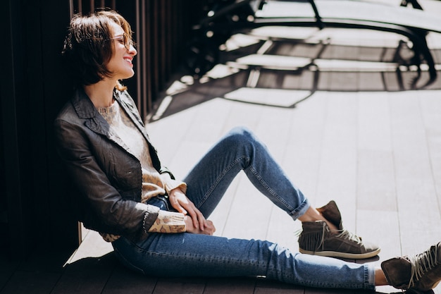 Free photo young woman model in jacket posing outside