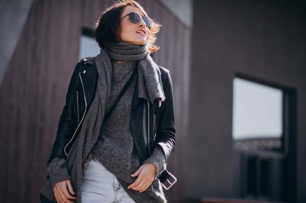 Free Photo young woman model in leather jacket outside the street