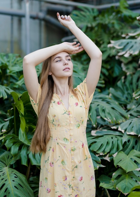 Free Photo young woman model posing in greenhouse