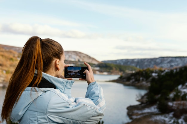 Free Photo young woman in nature taking photos