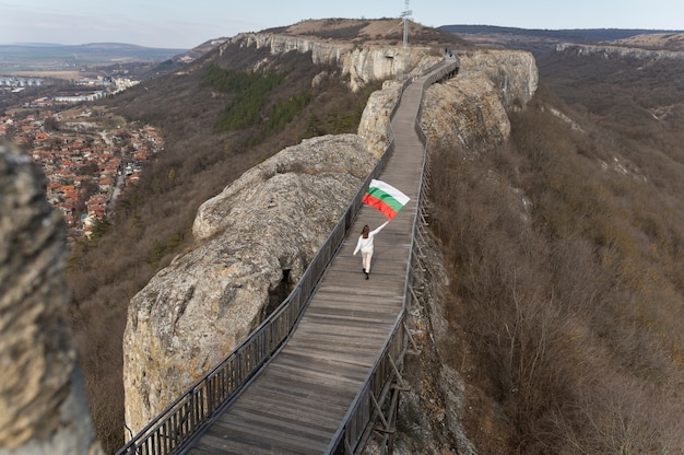 Young woman outdoors holding the bulgarian flag