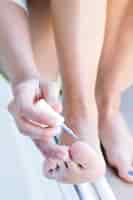 Free photo young woman painting her nails at home