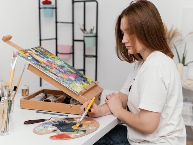 Young woman painting with acrylics