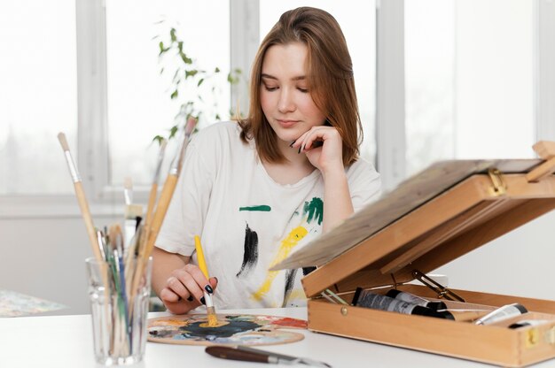 Young woman painting with acrylics