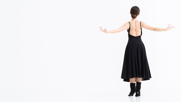 Young woman performing ballet with copy space