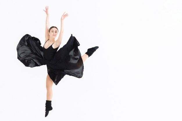 Young woman performing dance with copy space