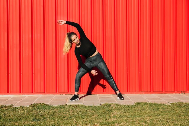 Young woman performing side bending