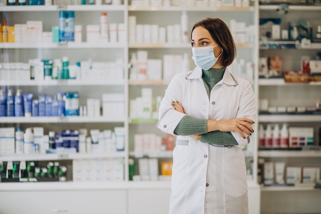 Free photo young woman pharmacist at pharmacy