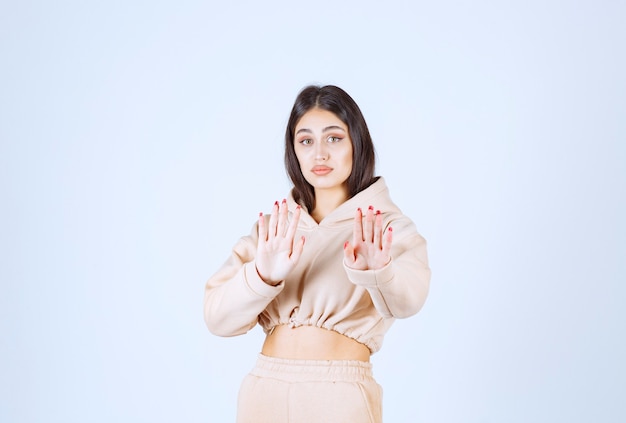 Young woman in a pink hoodie stopping someone