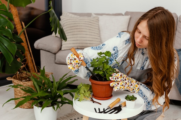 Free photo young woman planting at home